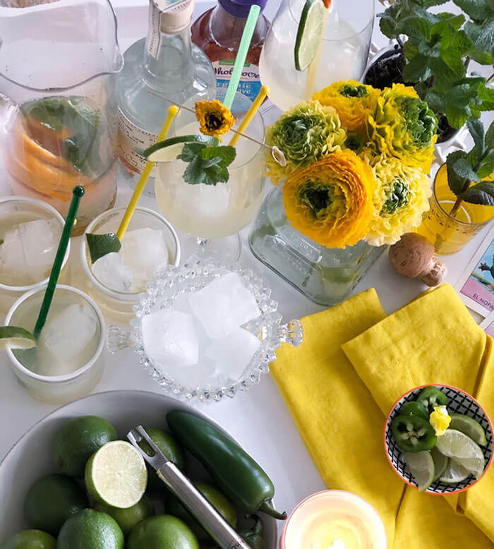 Table with margarita ingredients and flowers