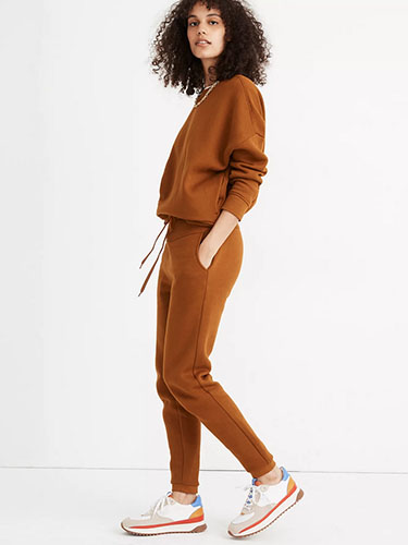 Model in matching terra cotta sweatsuit