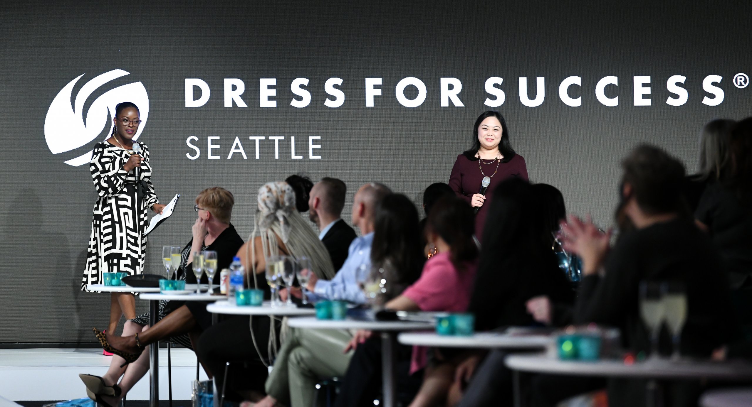 Two women, Keisha (L) and Belle (R) share the mission of Dress For Success on stage