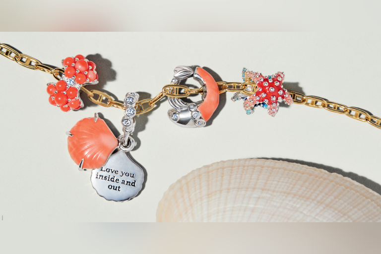 Add a splash of summer to your story with radiant new charms in coral and sparkle.